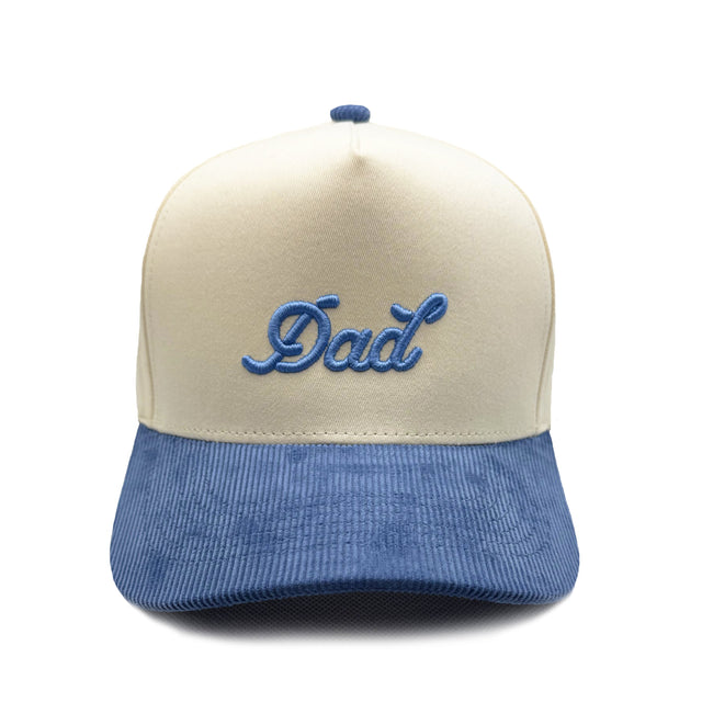 Blue and beige cap with 'Dad' embroidery on a white background